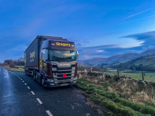 Gregory truck with scenic hills.